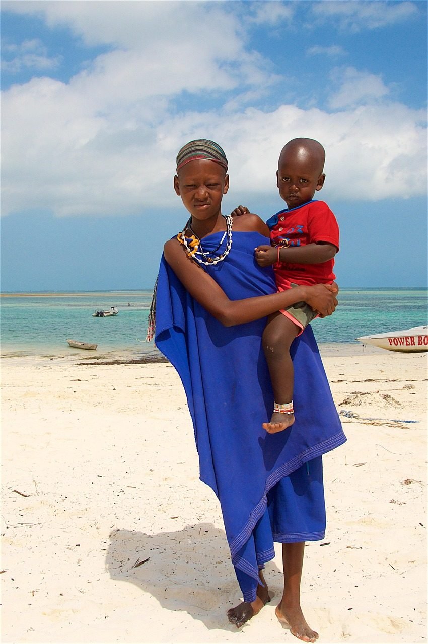 Parent and child enjoying a relaxed Zanzibar beach holiday