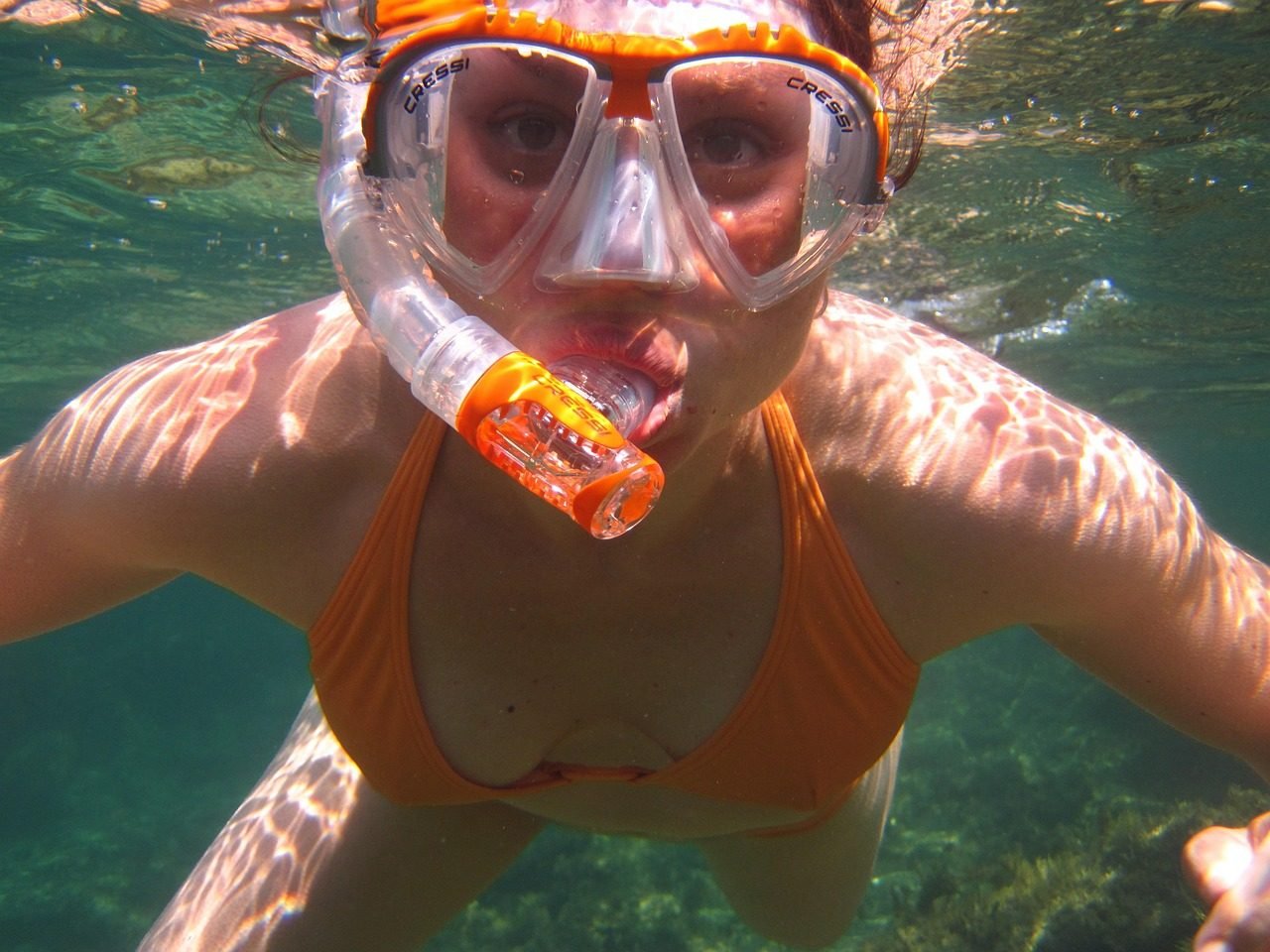 Snorkeler in clear tropical water for a Mnemba-style reef experience