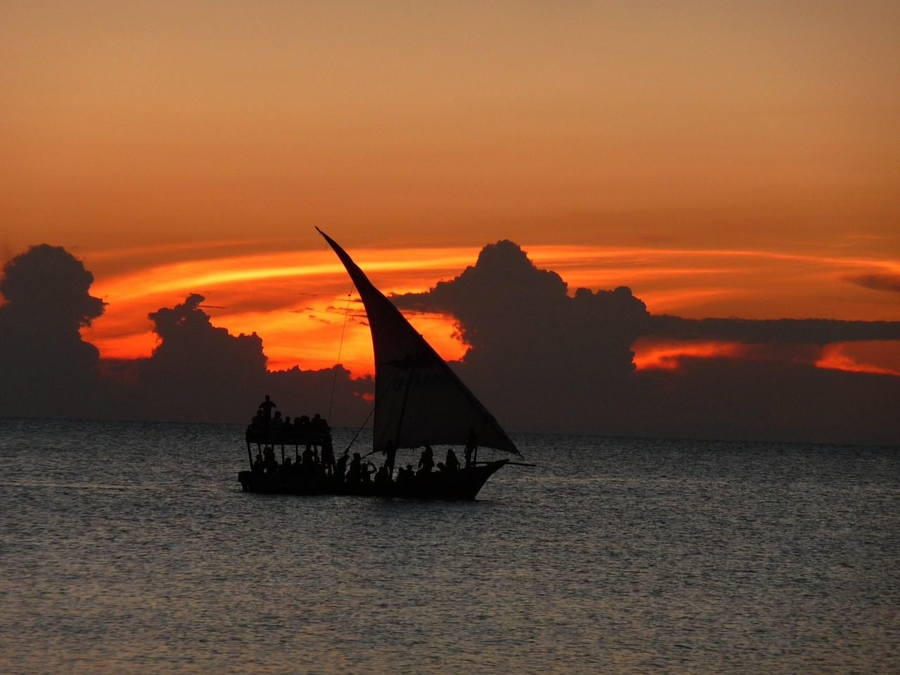 Dhow sailing at sunset on the Zanzibar coast